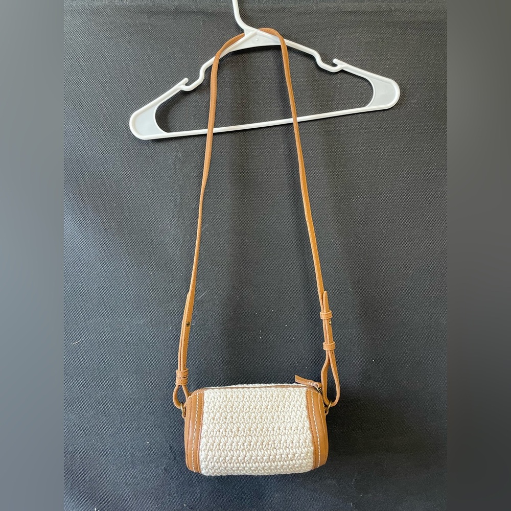 The Sak Paloma Barrel Crossbody bag with a crochet and leather design